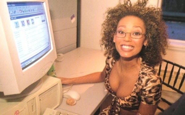 mel b on an old computer smiling at the camera